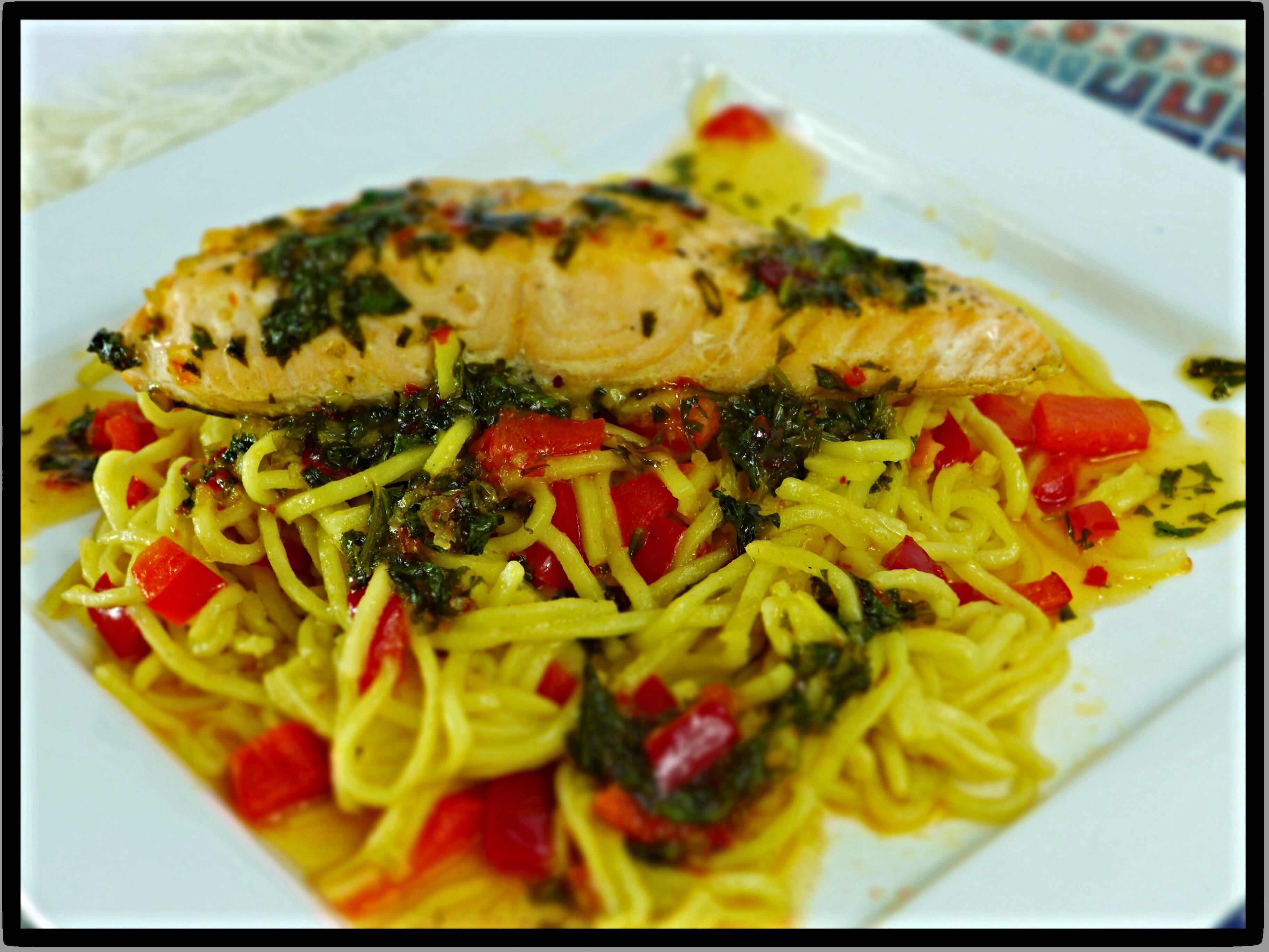 Scottish salmon on a bed of Asian ginger noodles finished with a sweet chilli and coriander butter