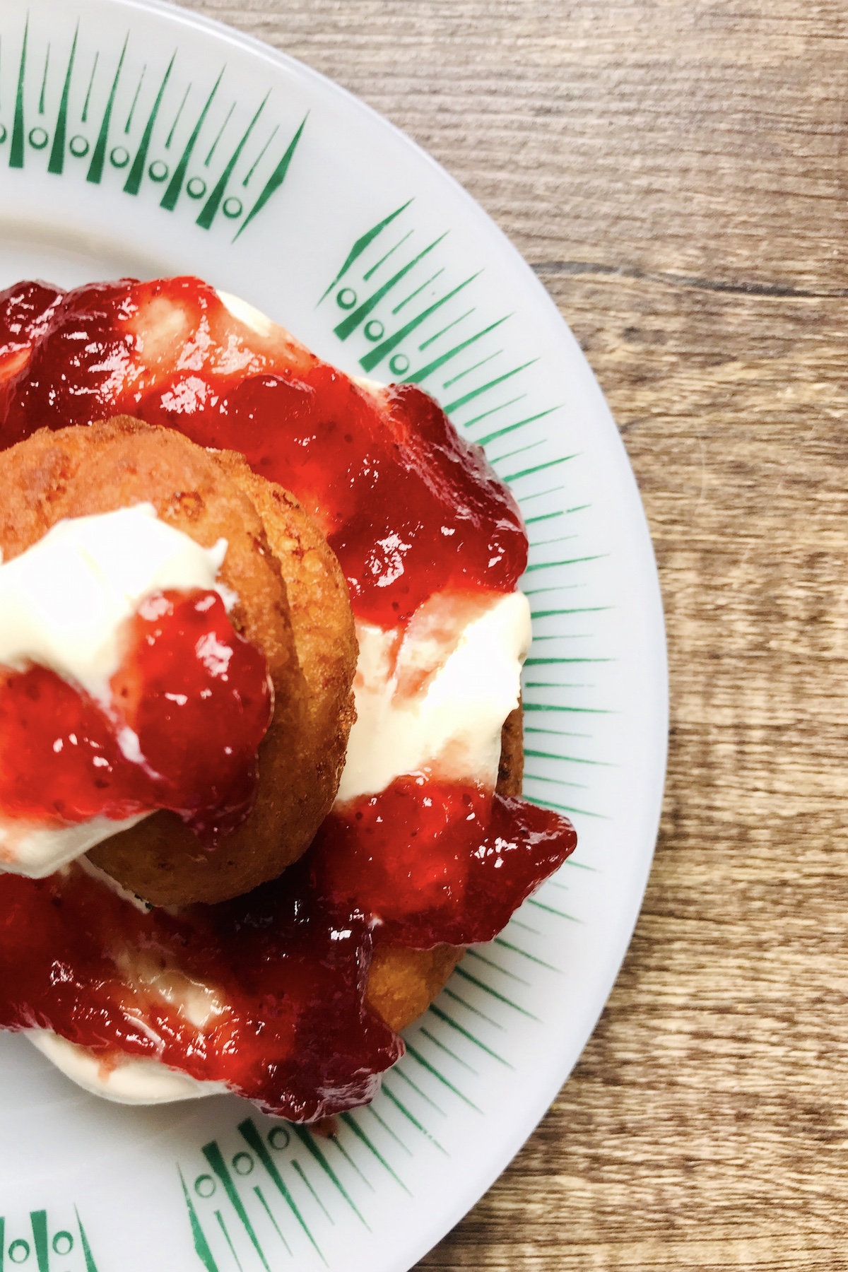 Traditional Romanian fried doughnuts – Papanași (papanash) – made with cottage cheese and topped with smetana and jam.