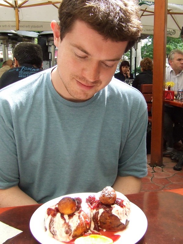 Traditional Romanian fried doughnuts – Papanași (papanash) – made with cottage cheese and topped with smetana and jam.