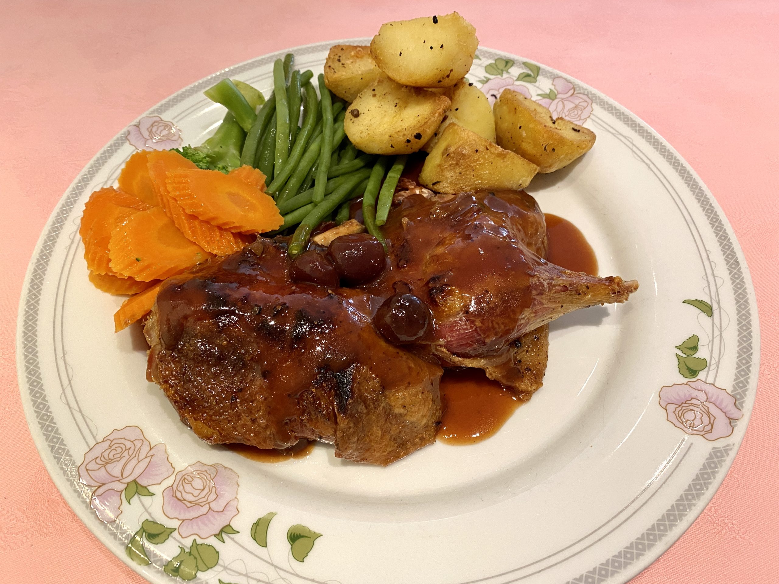 Crispy roast duck with cherry sauce and vegetables at Oslo Court London