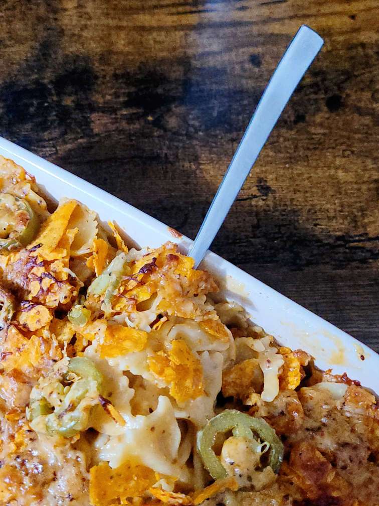 spicy mac and cheese recipe fork into mac and cheese dish