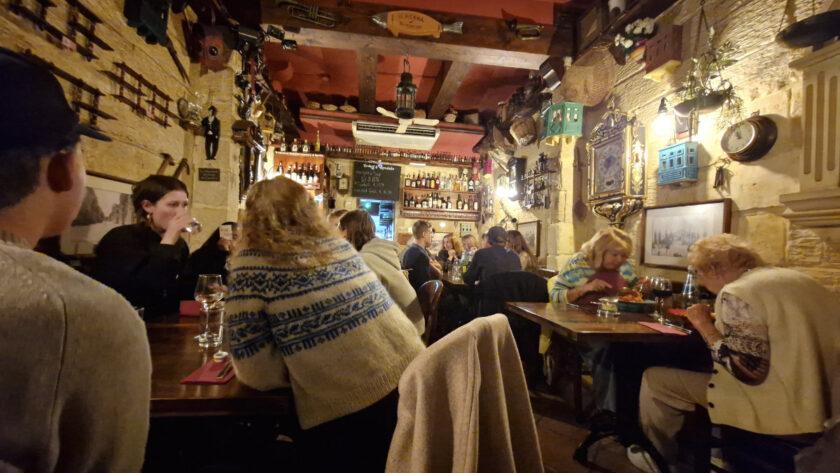Interior of Il-Merill restaurant in Sliema Malta showing quirky vintage decor and cosy dining space