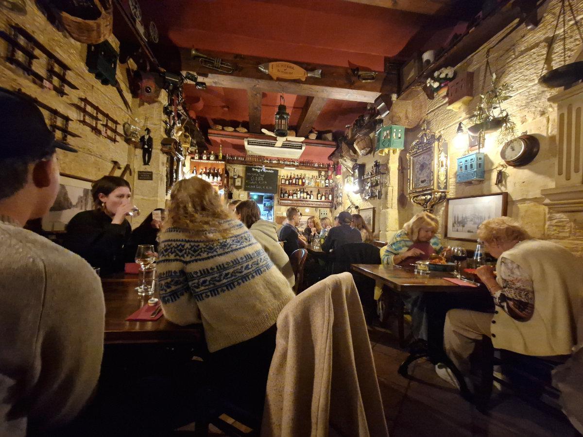 Interior of Il-Merill restaurant in Sliema Malta showing quirky vintage decor and cosy dining space