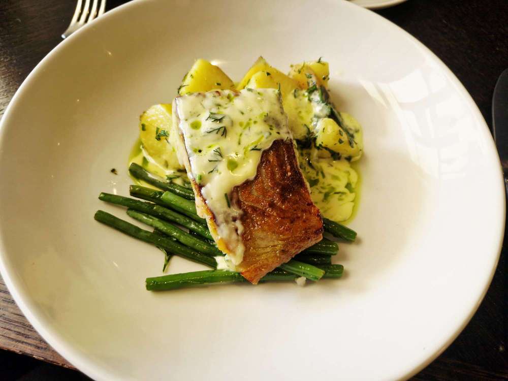 e pan-roasted coley is served with sauce vierge, baby potatoes and green beans.