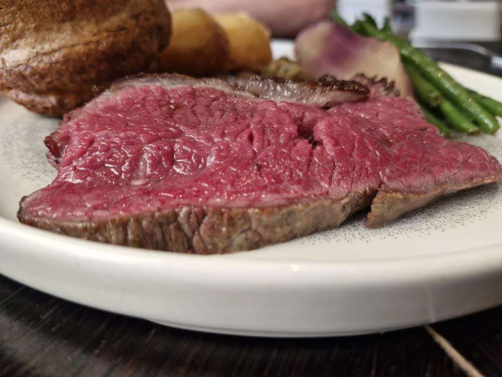 35-day-aged roast beef, accompanied by a Yorkshire pudding, beef-fat roast potatoes, cabbage, carrots, seasonal greens and red wine jus