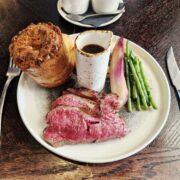 35-day-aged roast beef, accompanied by a Yorkshire pudding, beef-fat roast potatoes, cabbage, carrots, seasonal greens and red wine jus