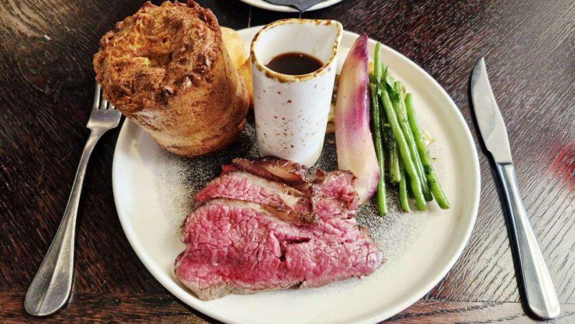 35-day-aged roast beef, accompanied by a Yorkshire pudding, beef-fat roast potatoes, cabbage, carrots, seasonal greens and red wine jus