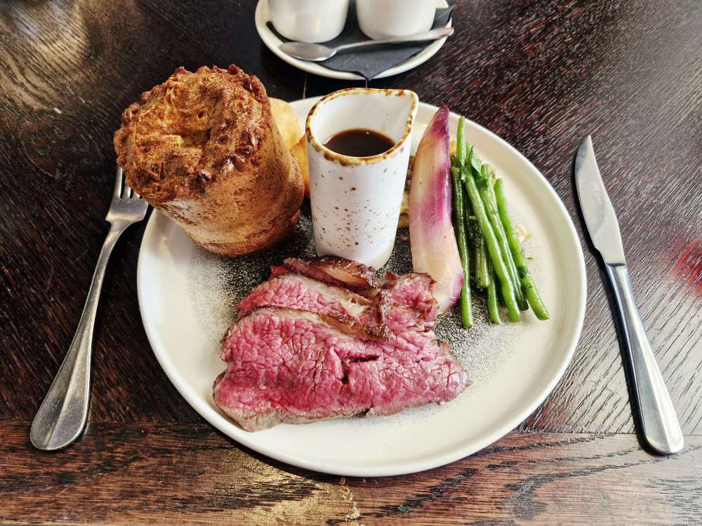 35-day-aged roast beef, accompanied by a Yorkshire pudding, beef-fat roast potatoes, cabbage, carrots, seasonal greens and red wine jus