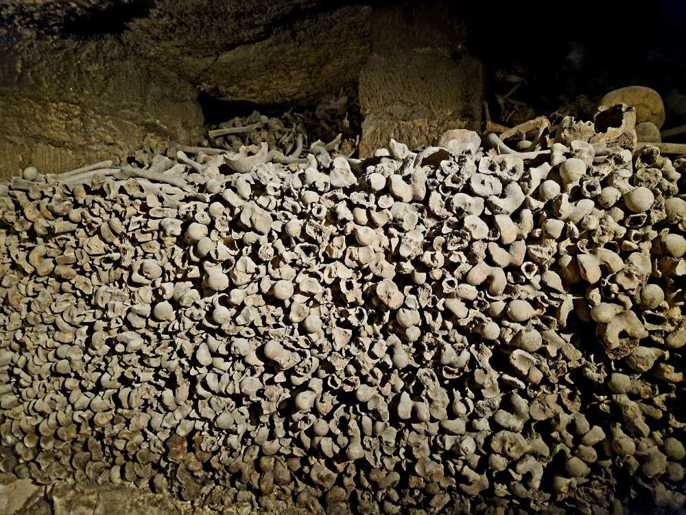 Underground ossuary walls in the Paris Catacombs