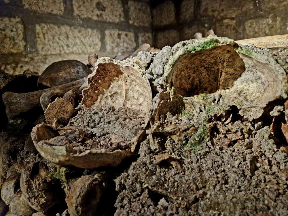 Human skulls and bones inside the Paris Catacombs
